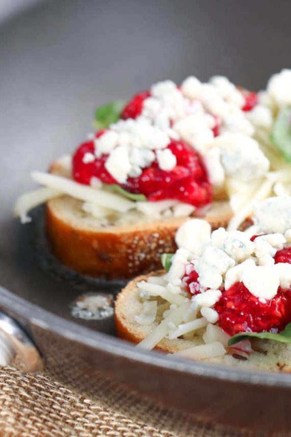 Adding the garnish to a Grilled Raspberry, Basil and Blue Cheese Sandwich