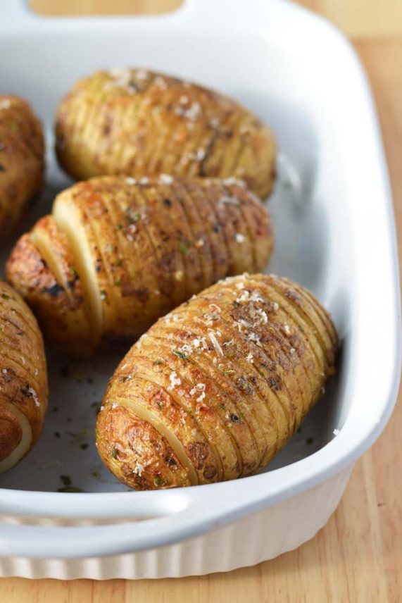 Preparing a pan of Caesar Hasselback Potatoes