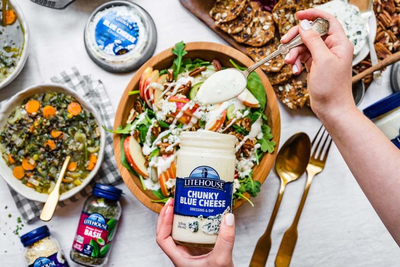 Drizzling Chunky Blue Cheese Dressing on Apple Pecan Blue Cheese Salad