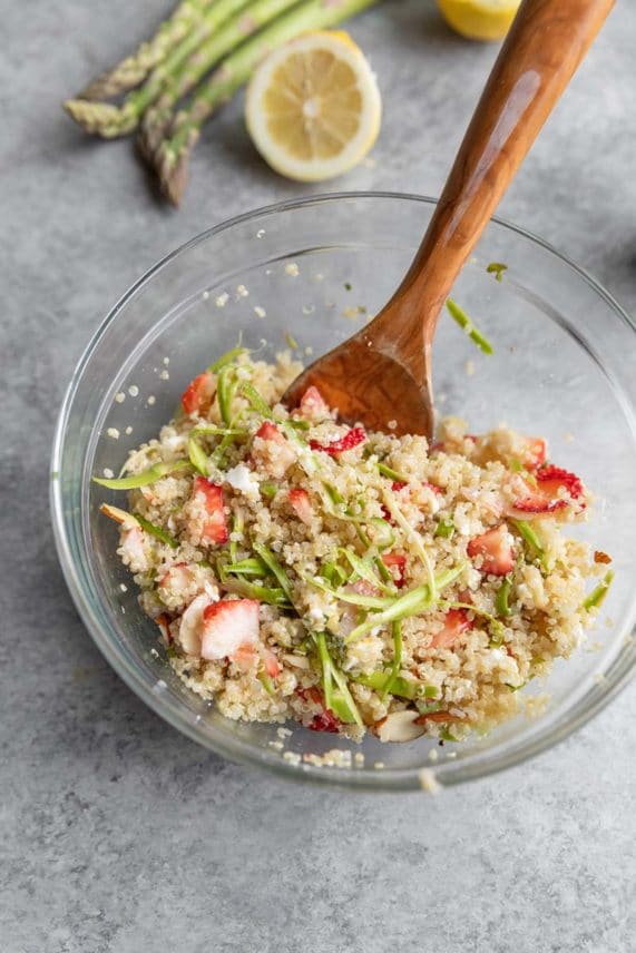 Mixing feta cheese crumbles into Strawberry Feta Quinoa Salad