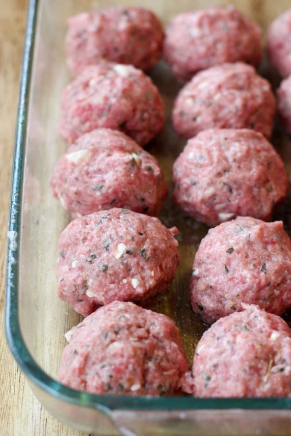 Preparing a baking tray of Pomegranate Glazed Meatballs